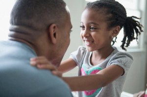 Close-up of young daughter looking into dad's eyes.